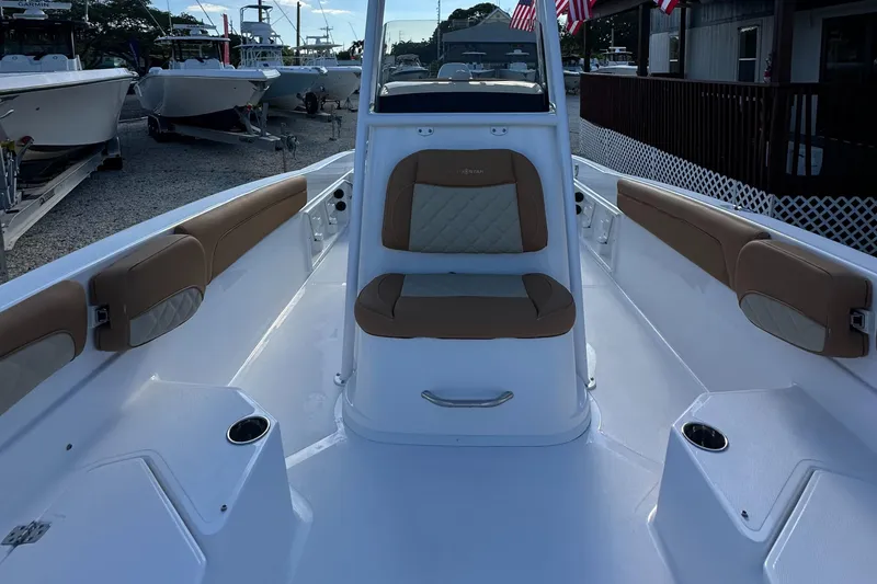 Slide: The Image of 2025 NauticStar 231 Hybrid boat interior with cushioned seating and cup holders. - 30