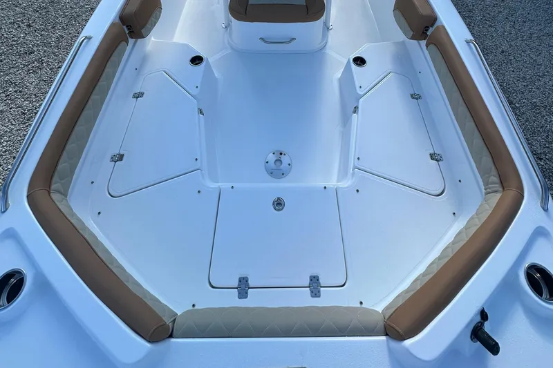 Slide: The Image of 2025 NauticStar 231 Hybrid boat interior with tan seating and white deck. - 31