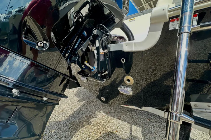 Slide: The Image of 2024 NauticStar 22XS boat engine and transom detail in sunlight. - 6