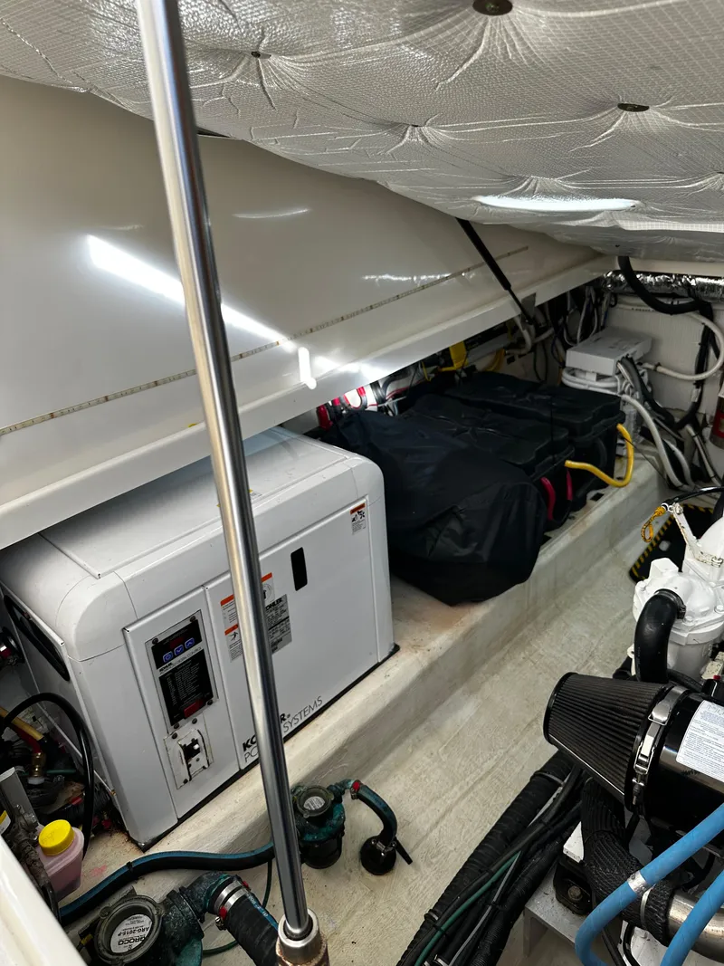 Slide: The Image of Engine compartment of 2010 Back Cove 33 Hardtop Express boat, showing generator and wiring. - 24