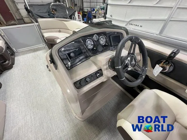 Slide: The Image of 2025 Tahoe LTZ 2385 Elite Cruise Tritoon interior with modern dashboard and steering wheel. - 11