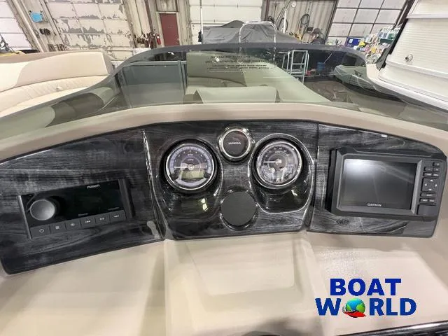 Slide: The Image of Dashboard of 2025 Tahoe LTZ 2385 Elite Cruise Tritoon with Garmin display. - 13