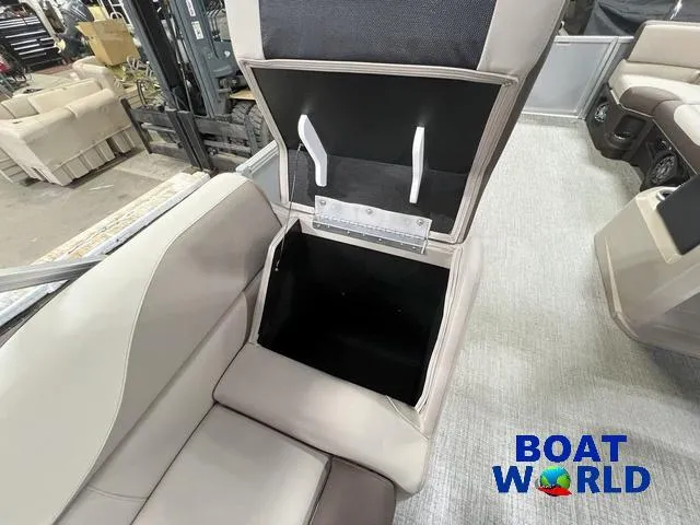 Slide: The Image of 2025 Tahoe LTZ 2385 Elite Cruise Tritoon interior storage compartment, Boat World logo visible. - 18