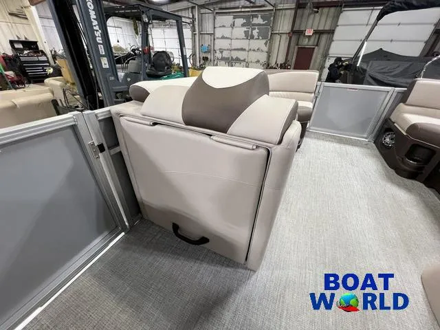 Slide: The Image of 2025 Tahoe LTZ 2385 Elite Cruise Tritoon interior with plush seating in showroom. - 19