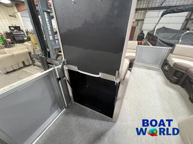 Slide: The Image of 2025 Tahoe LTZ 2385 Elite Cruise Tritoon interior with storage compartment, Boat World logo. - 20