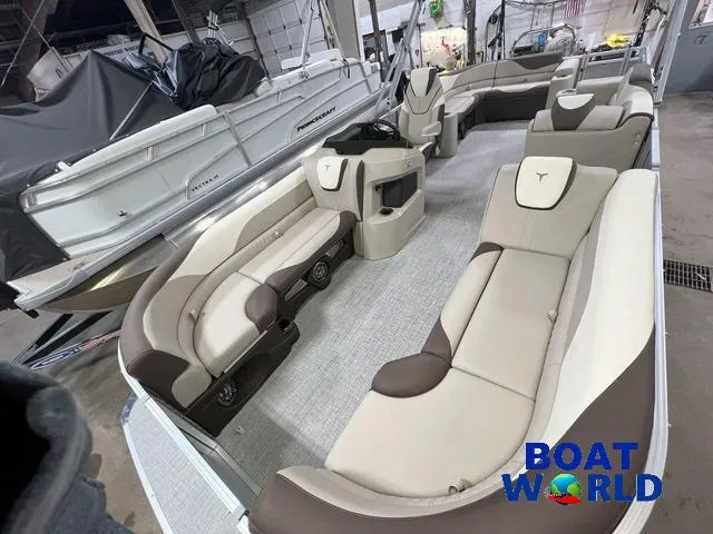 Slide: The Image of 2025 Tahoe LTZ 2385 Elite Cruise Tritoon interior with luxurious seating in showroom. - 21