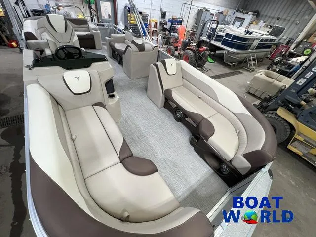 Slide: The Image of 2025 Tahoe LTZ 2385 Elite Cruise Tritoon interior with luxurious seating in showroom. - 22