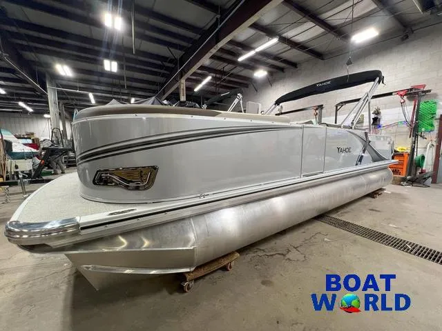 Slide: The Image of 2025 Tahoe LTZ 2385 Elite Cruise Tritoon in showroom, featuring Honda 4-Stroke EFI engine. - 29