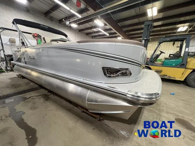 Slide: The Image of 2025 Tahoe LTZ 2385 Elite Cruise Tritoon in a warehouse setting. - 30