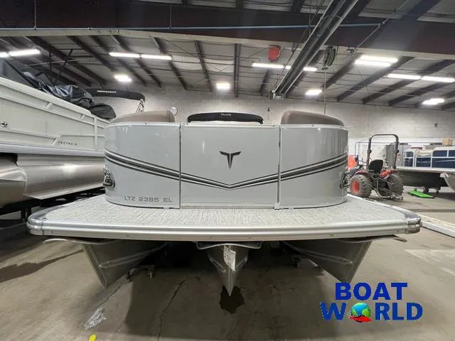 Slide: The Image of 2025 Tahoe LTZ 2385 Elite Cruise Tritoon in showroom, featuring Honda 4-Stroke EFI engine. - 31