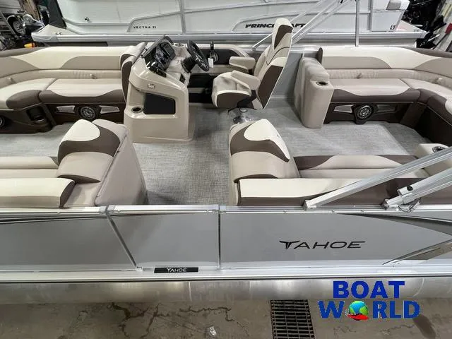 Slide: The Image of 2025 Tahoe LTZ 2385 Elite Cruise Tritoon interior with beige seating and steering console. - 4