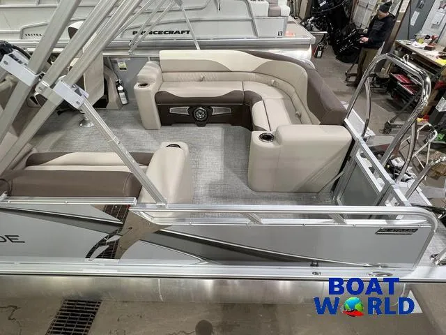 Slide: The Image of 2025 Tahoe LTZ 2385 Elite Cruise Tritoon interior with plush seating, showcased at Boat World. - 5