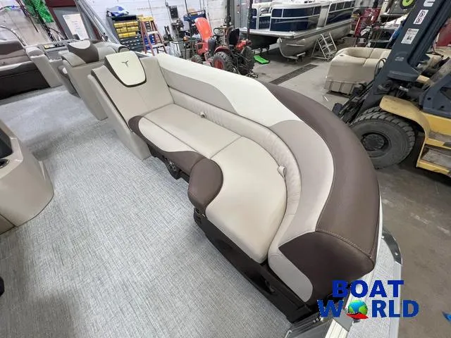 Slide: The Image of 2025 Tahoe LTZ 2385 Elite Cruise Tritoon interior with plush seating in showroom. - 8