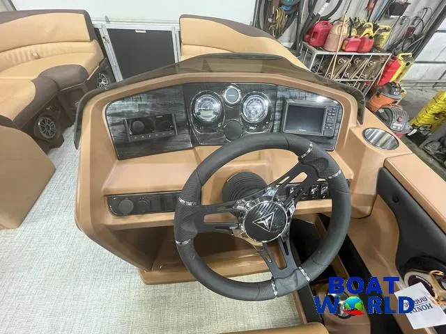 Slide: The Image of 2025 Tahoe LTZ 2385 Quad Lounge boat dashboard with steering wheel and controls. - 12
