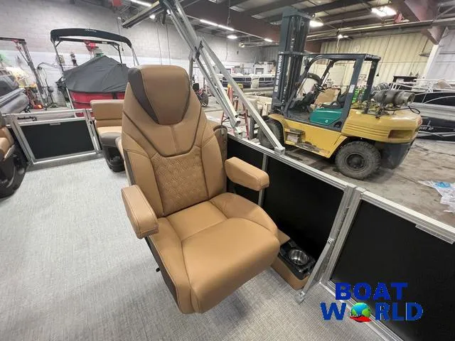 Slide: The Image of 2025 Tahoe LTZ 2385 Quad Lounge interior with luxurious captain's chair in a showroom. - 14