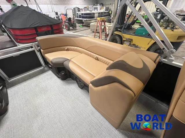 Slide: The Image of 2025 Tahoe LTZ 2385 Quad Lounge interior with tan seating in a showroom. - 16