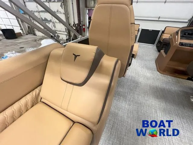 Slide: The Image of 2025 Tahoe LTZ 2385 Quad Lounge interior with tan leather seating, showcased at Boat World. - 17