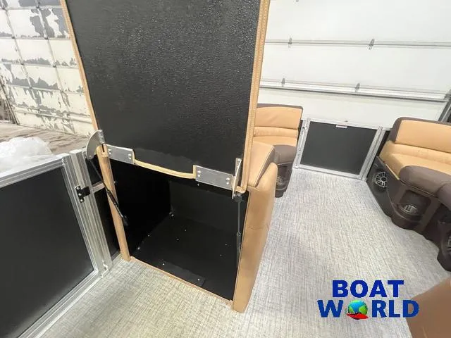 Slide: The Image of 2025 Tahoe LTZ 2385 Quad Lounge interior with tan seating and storage compartment. - 20