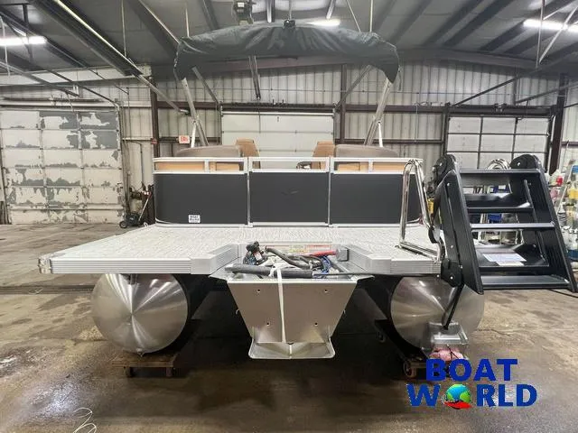 Slide: The Image of 2025 Tahoe LTZ 2385 Quad Lounge pontoon boat in a warehouse setting. - 25