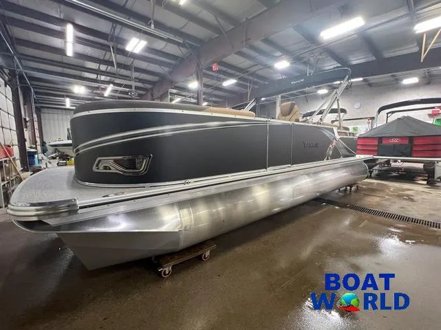 Slide: The Image of 2025 Tahoe LTZ 2385 Quad Lounge pontoon boat in showroom, featuring Honda 4-Stroke EFI engine. - 29