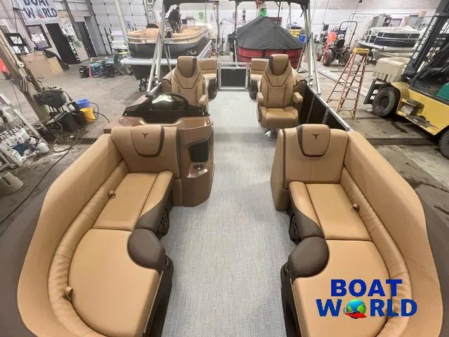 Slide: The Image of 2025 Tahoe LTZ 2385 Quad Lounge interior with tan seating in a showroom. - 6