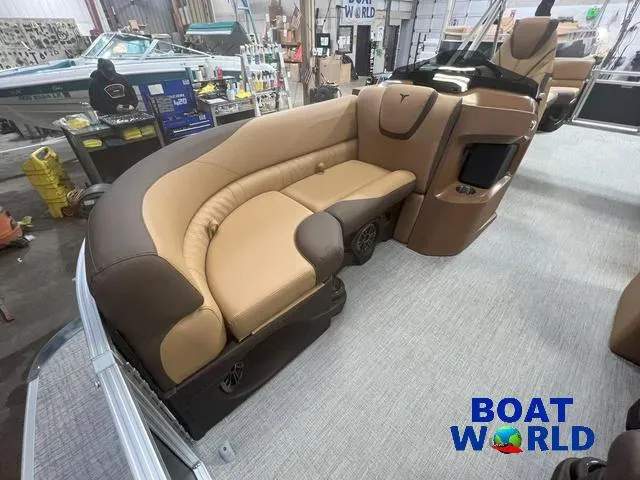 Slide: The Image of 2025 Tahoe LTZ 2385 Quad Lounge interior with tan seating, showcased at Boat World. - 7