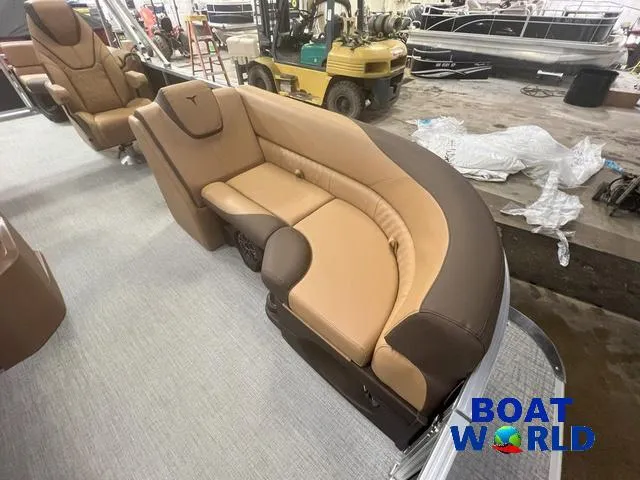 Slide: The Image of 2025 Tahoe LTZ 2385 Quad Lounge interior with tan and brown seating at Boat World. - 8