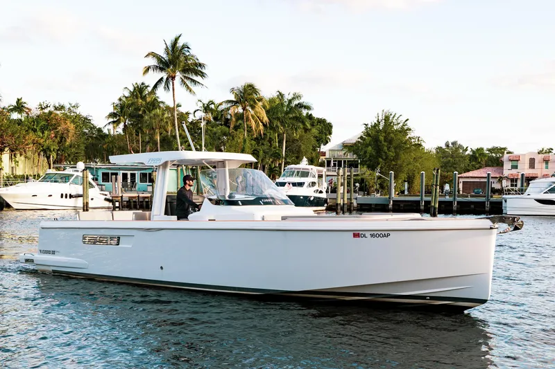 The Image of 2022 Fjord 38 Open yacht cruising near palm-lined marina. - 0