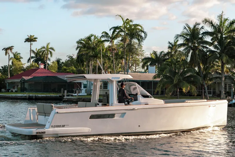 Slide: The Image of 2022 Fjord 38 Open yacht cruising on a tropical waterway with palm trees. - 1