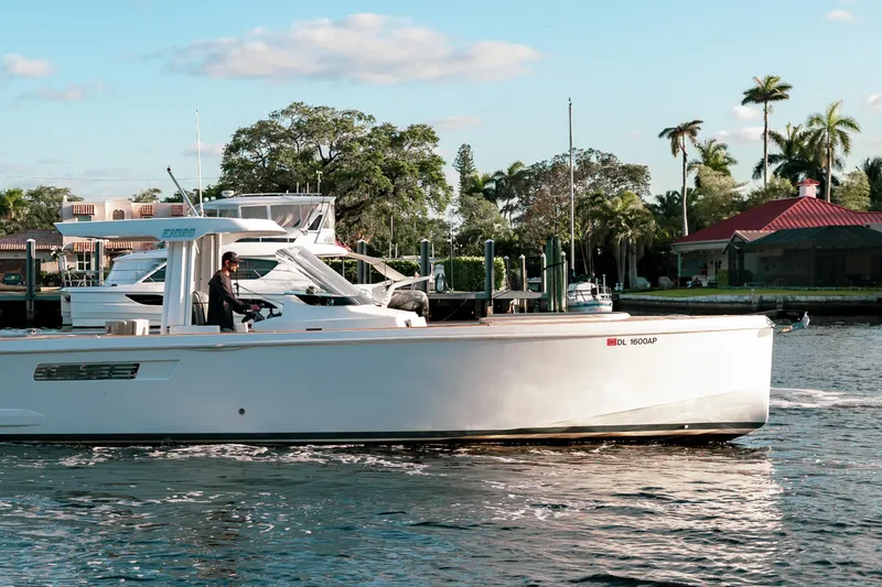 Slide: The Image of 2022 Fjord 38 Open boat cruising on a sunny day near a marina. - 11