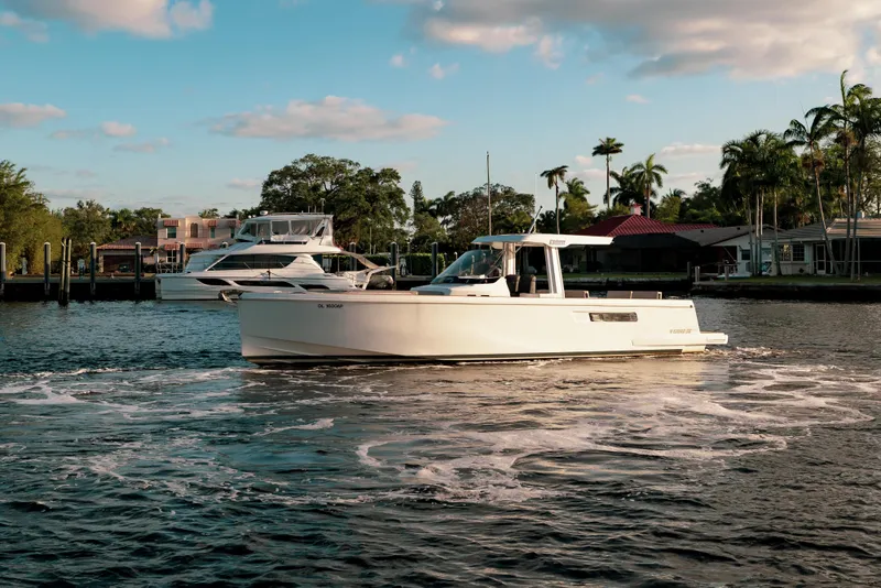 Slide: The Image of 2022 Fjord 38 Open boat cruising on a sunny day near a marina. - 13