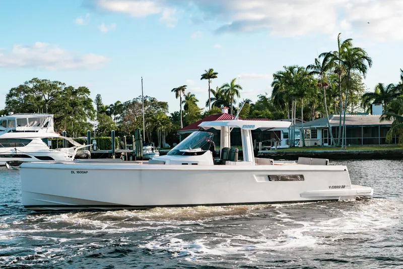 Slide: The Image of 2022 Fjord 38 Open cruising on a scenic waterway with palm trees in the background. - 14