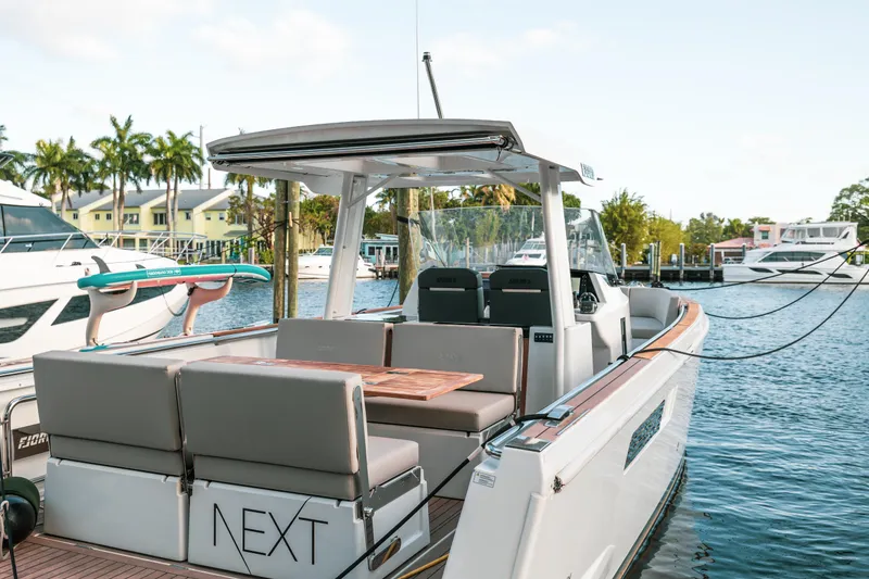 Slide: The Image of 2022 Fjord 38 Open boat docked, featuring sleek design and spacious seating area. - 19