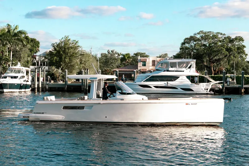 Slide: The Image of 2022 Fjord 38 Open yacht cruising in a scenic marina setting. - 2