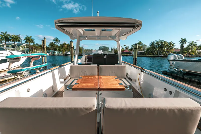 Slide: The Image of 2022 Fjord 38 Open yacht with spacious deck, docked by palm trees under clear blue sky. - 31