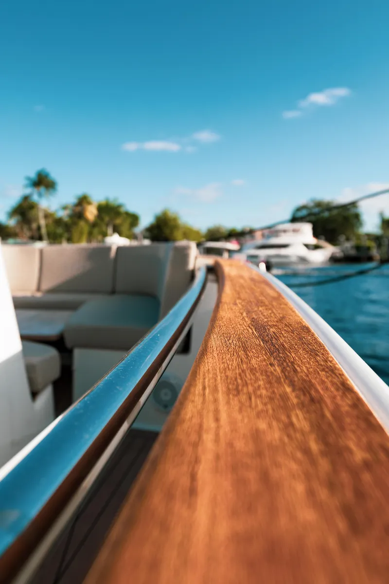 Slide: The Image of 2022 Fjord 38 Open yacht with sleek wooden railing and scenic water view. - 32