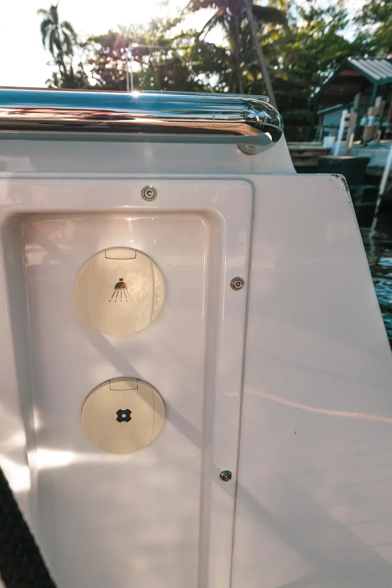 Slide: The Image of 2022 Fjord 38 Open yacht detail with sunlit deck and palm trees. - 33