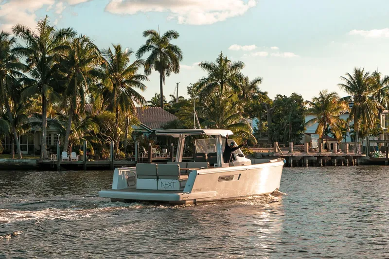 Slide: The Image of 2022 Fjord 38 Open cruising on a tropical waterway with palm trees. - 4