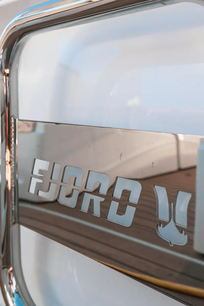 Slide: The Image of Close-up of 2022 Fjord 38 Open boat logo on metallic surface. - 41