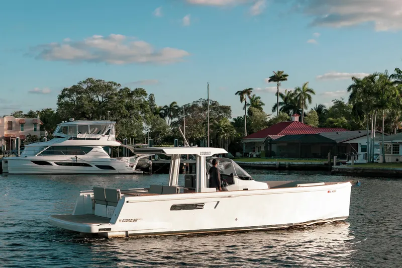 Slide: The Image of 2022 Fjord 38 Open boat cruising on a sunny day near waterfront homes. - 6