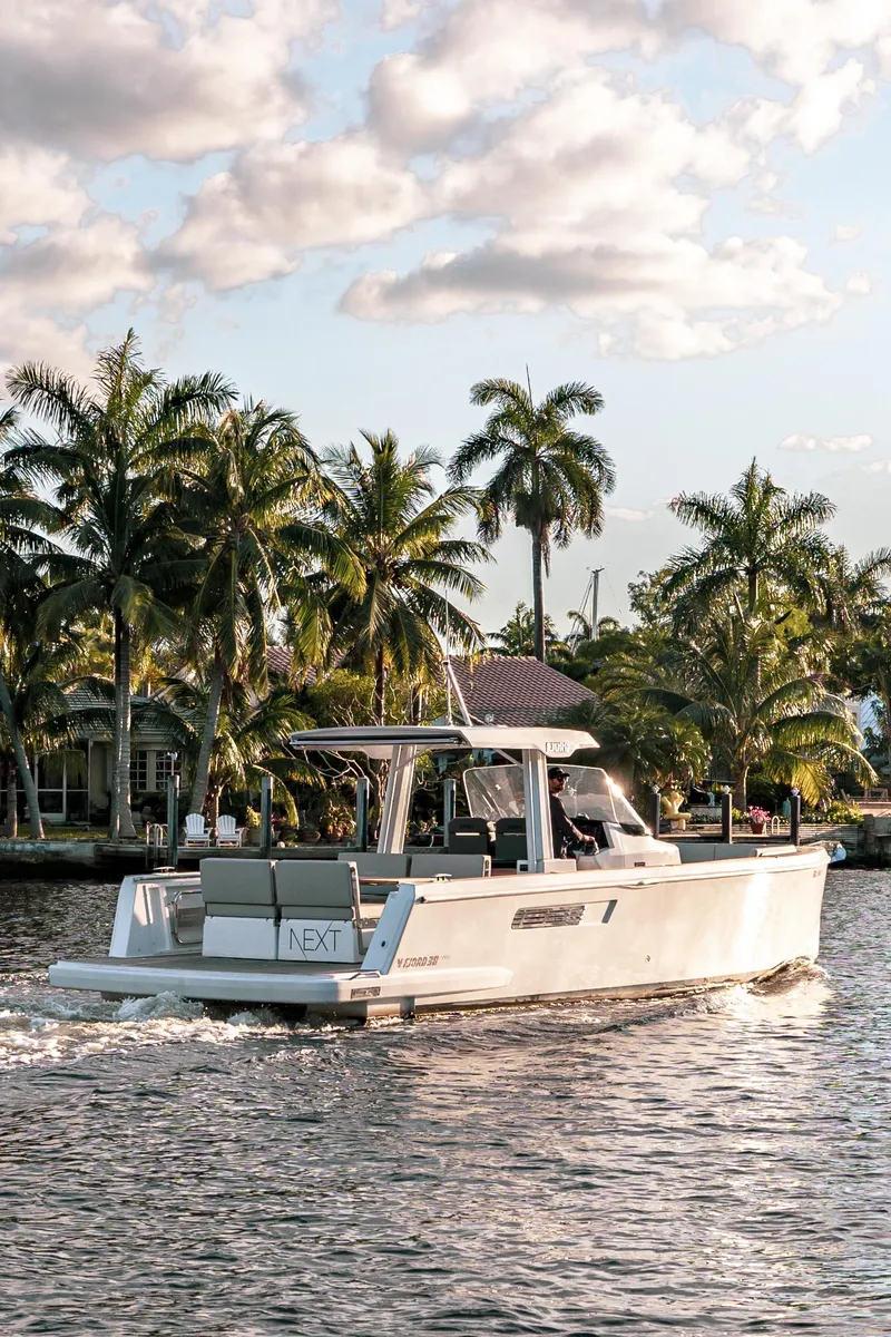 Slide: The Image of 2022 Fjord 38 Open cruising on a tropical waterway with palm trees. - 7