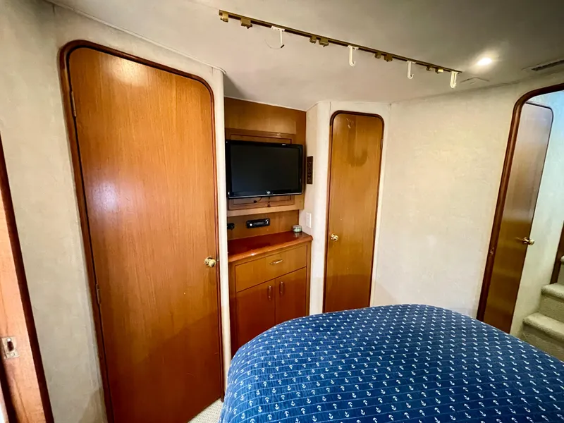 Slide: The Image of Interior cabin of 2000 Ocean Yachts 43 Super Sport with TV and wooden cabinetry. - 11