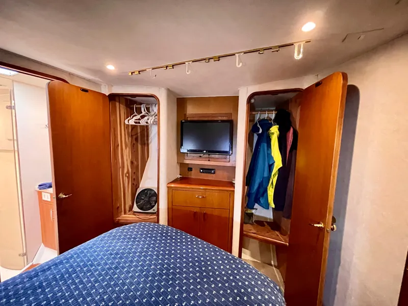 Slide: The Image of Interior of 2000 Ocean Yachts 43 Super Sport with closets, TV, and bed. - 12
