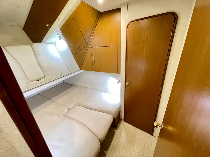 Slide: The Image of Interior cabin of 2000 Ocean Yachts 43 Super Sport with cozy seating and wooden accents. - 14