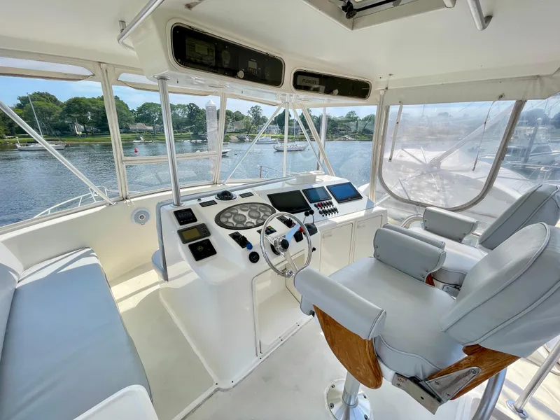 Slide: The Image of Luxurious helm of 2000 Ocean Yachts 43 Super Sport, featuring modern controls and seating. - 19