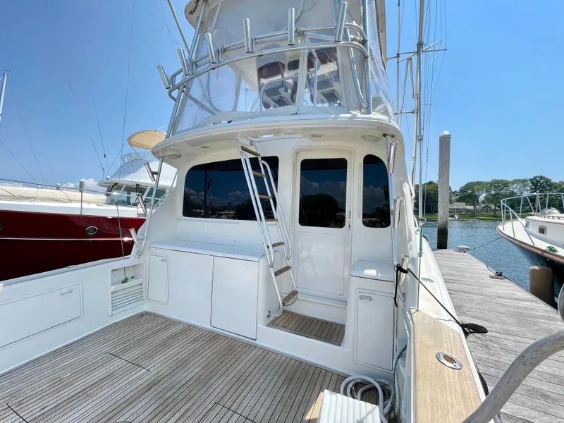 Slide: The Image of 2000 Ocean Yachts 43 Super Sport docked, showcasing sleek design and spacious deck. - 2