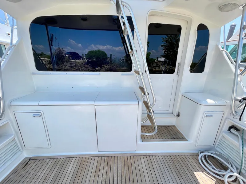 Slide: The Image of 2000 Ocean Yachts 43 Super Sport yacht deck with sleek white cabinetry and ladder. - 3