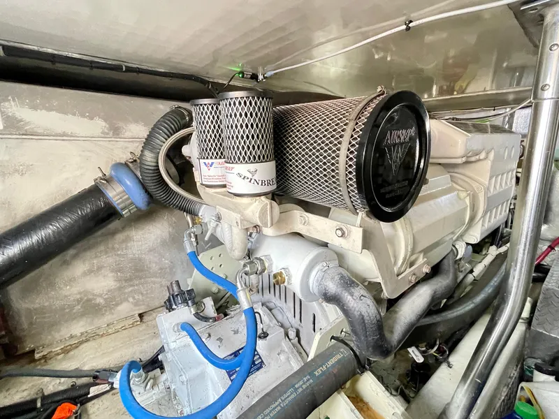 Slide: The Image of Engine room of 2000 Ocean Yachts 43 Super Sport with visible components and hoses. - 44