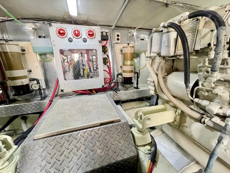 Slide: The Image of Engine room of 2000 Ocean Yachts 43 Super Sport, showcasing mechanical components and controls. - 46