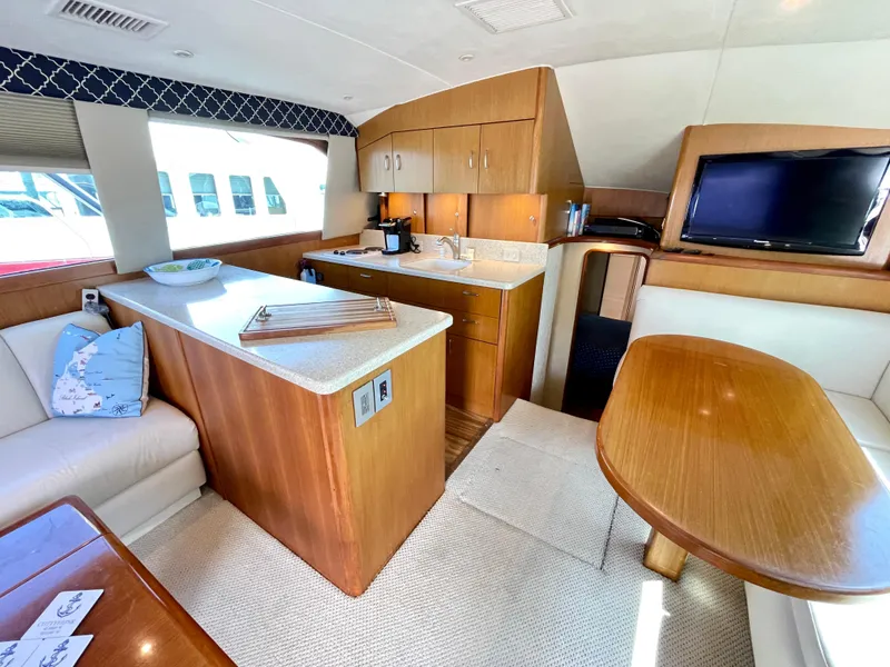 Slide: The Image of Luxurious interior of 2000 Ocean Yachts 43 Super Sport with kitchen and seating area. - 7
